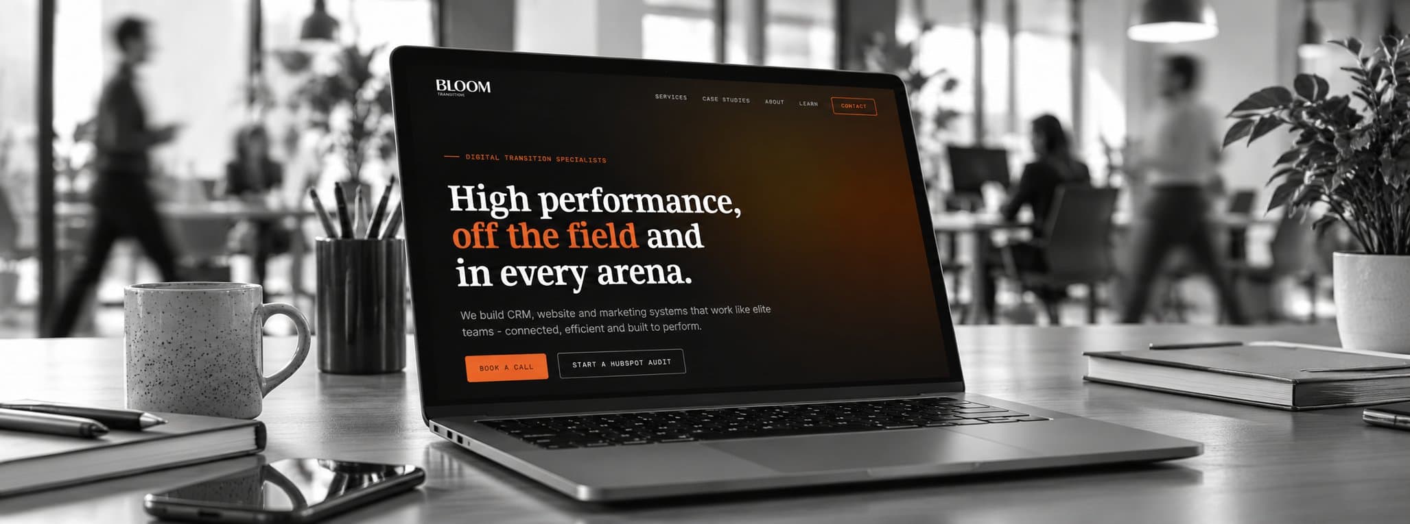 A monochrome office with warm orange digital accents